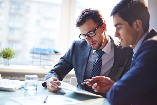 Two men planning on a tablet